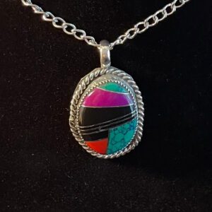 A colorful stone is on the silver chain.