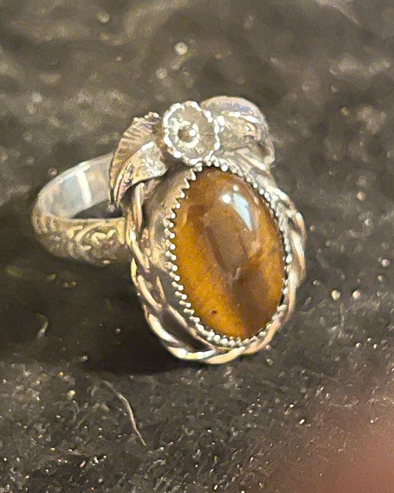 A ring with a stone on it's side.