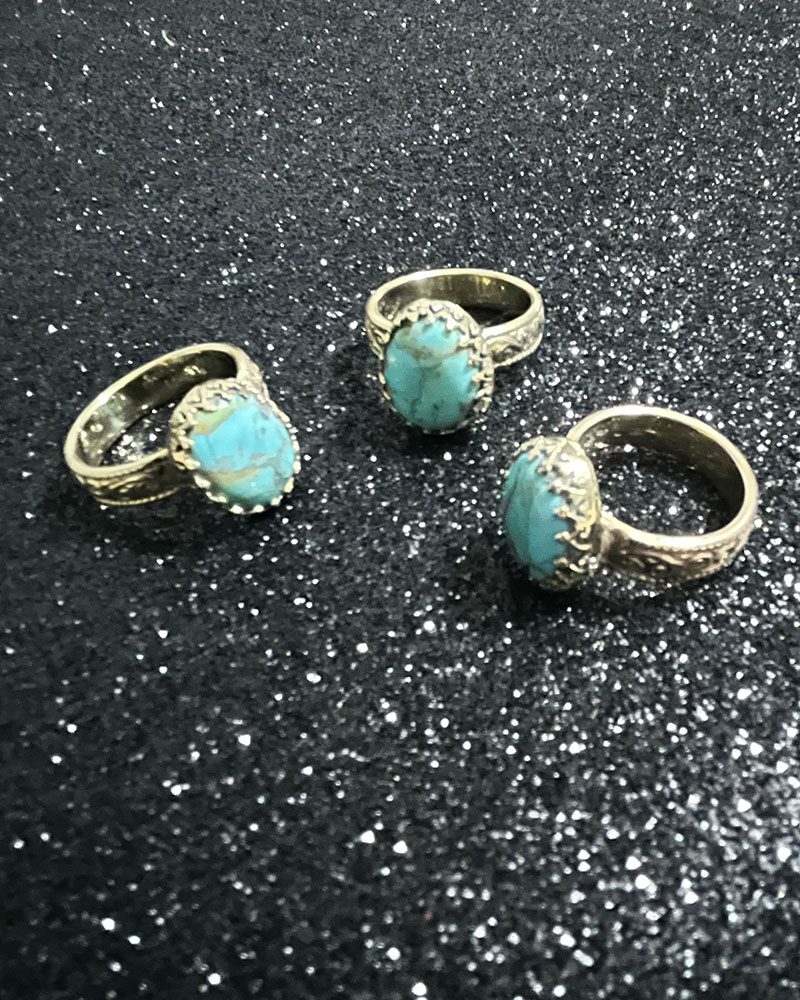 Three rings with a blue stone on top of them.