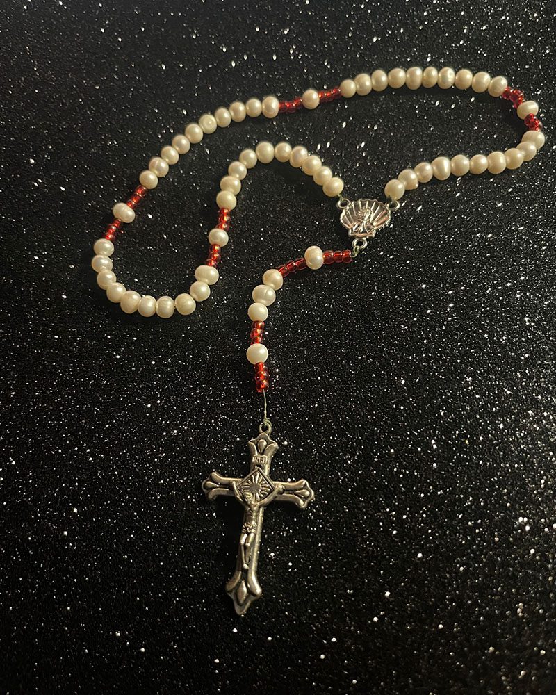 A rosary with a cross on it.