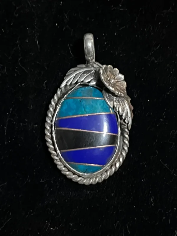 A blue and black stone in a silver frame.