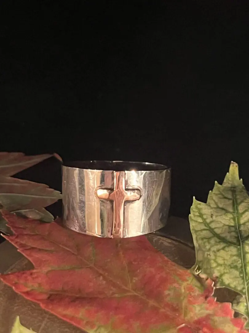 Silver ring with a cross design.