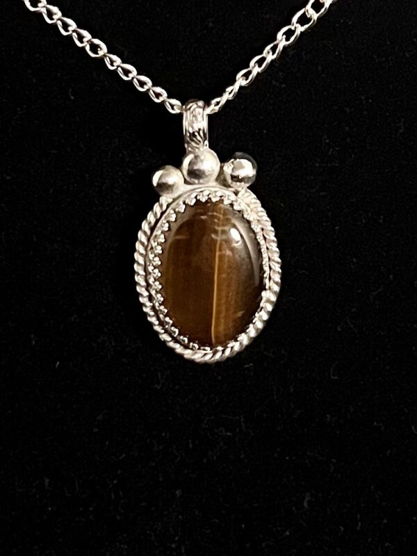 Silver chain with brown tiger's eye pendant.