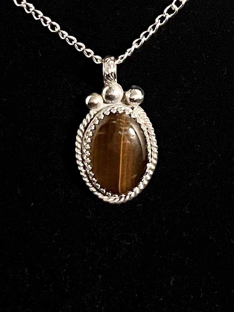 Silver chain with brown tiger's eye pendant.