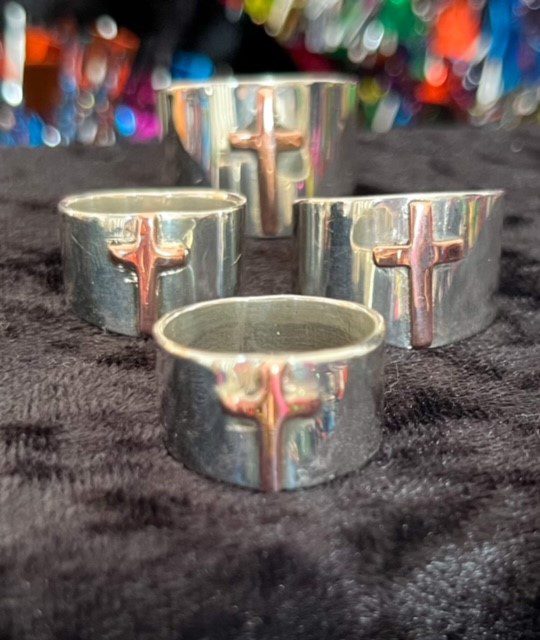 Silver rings with copper cross designs.